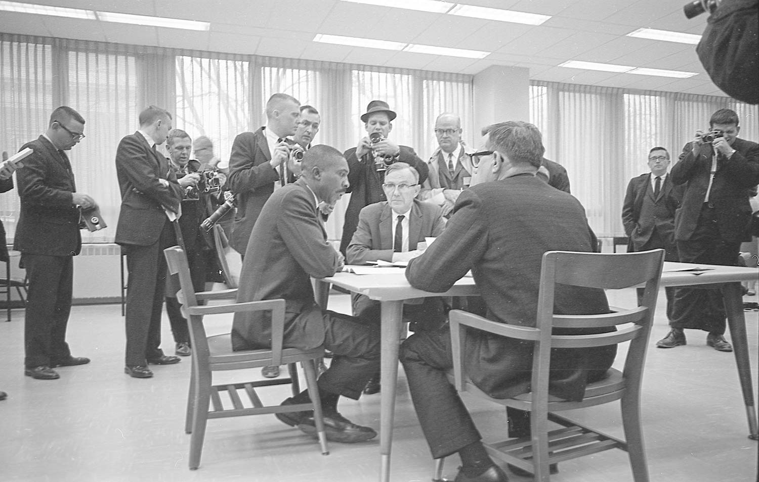 Harold Franklin sits a conference table with other men